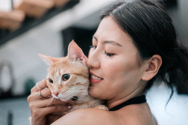 istock Woman Cuddles Cat At Home 2158649369