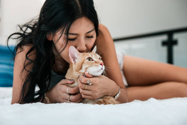 istock Woman Cuddles Cat At Home 2158649428