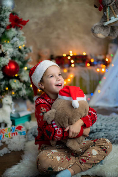 istock Boy hugs a stuffed toy during Christmas at home 2158649653
