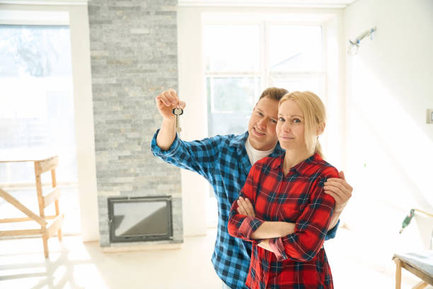 istock Man standing and embracing lady while holding keys in hand 2158653683