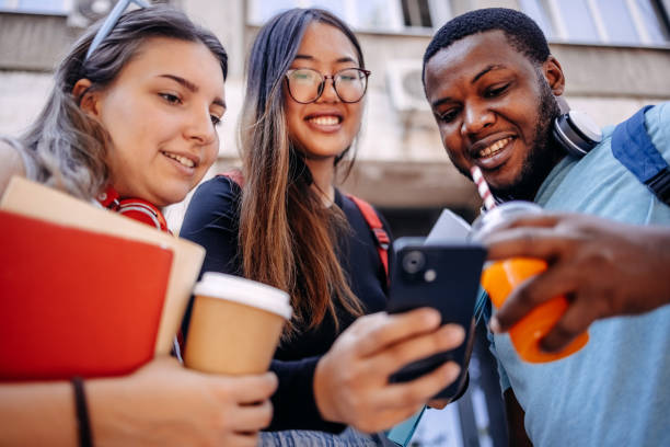 istock Multiracial group of students standing in front of University after class 2158653803