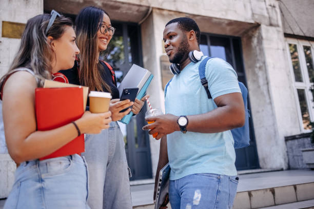 istock Multiracial group of students standing in front of University after class 2158653812