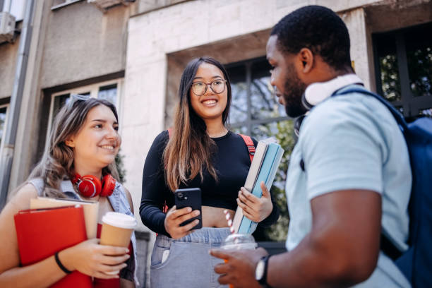 istock Multiracial group of students standing in front of University after class 2158653819