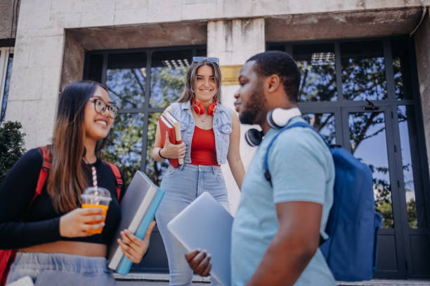 istock Multiracial group of students standing in front of University after class 2158653855