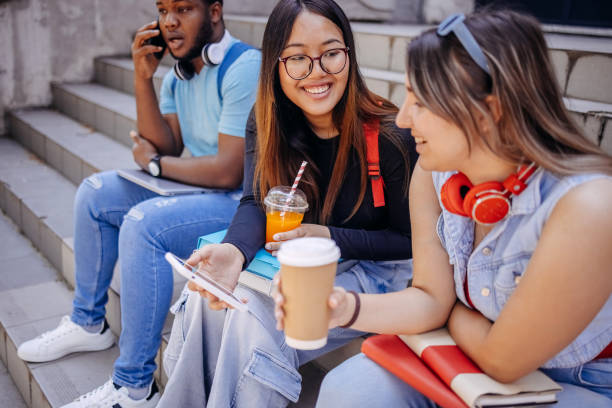istock Multiracial group of students in front of University after class using mobile phones 2158653898