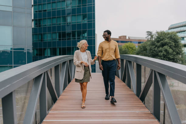 istock Business professionals walking over modern bridge 2158655907