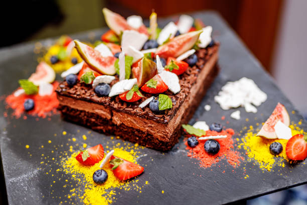 The chocolate cake adorned with fresh fruits and mint leaves
