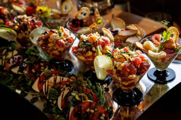 istock Glass cups hold layered salads, garnished with zesty lime slices, while surrounding plates feature additional salads and accompaniments 2158656203