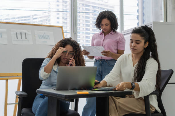 istock Team of Young Professional Women Multitasking in Office 2158659302