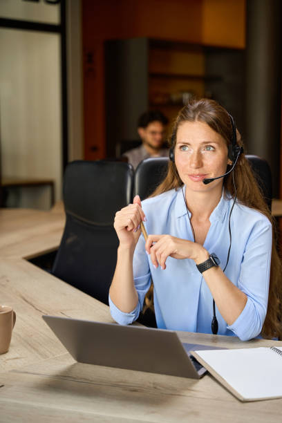 istock Selective focus of young female caucasian call center operator looking away 2158659867