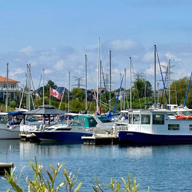 clarington, canada - september 07 2023: the marina with motorboats and sailing boats docked in it on the lake ontario at a new developed port