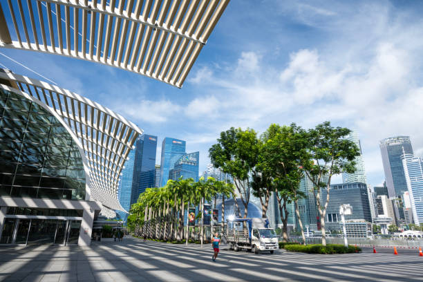 Singapore, Singapore - April 1, 2024. Man running on Bayfront promenade in downtown Singapore