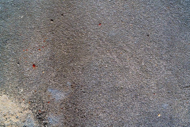 Old dirty scratched plaster wall texture as grunge background.