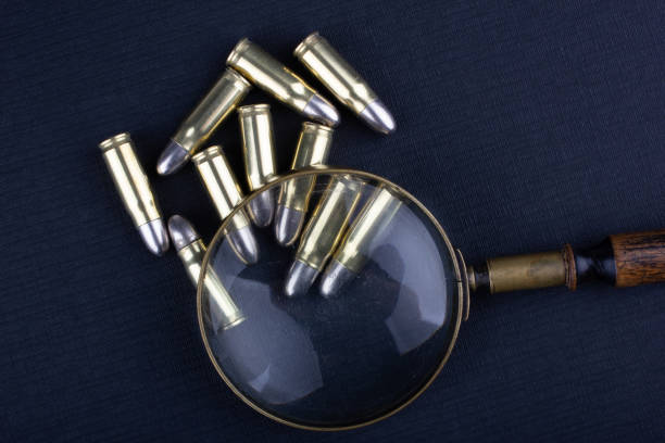 cartridges with a detective's magnifying glass on a black background