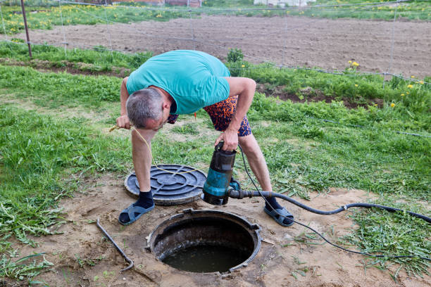 istock Man uses sewage submersible pump for pumping wastewater containing fecal matter from septic tank. 2158667733