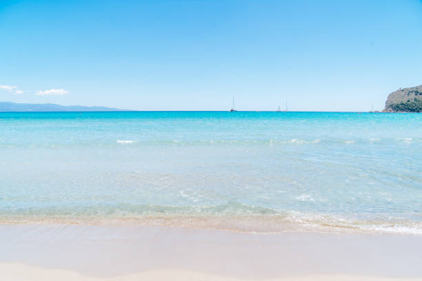 Turquoise sea water and blue sky in the beautiful beach of Porto Ainu in Sardinia, Italy