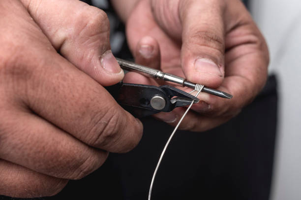 istock A man uses a flush cutter to snip the coil wire wrapped around the jig. Forming a coil loop for a mod box vape build. 2158668179