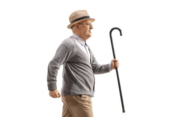 istock Elderly man running and holding a walking cane 2158668337