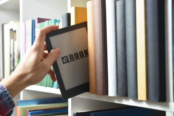 istock Hand taking an ebook from a shelf full of books 2158671546
