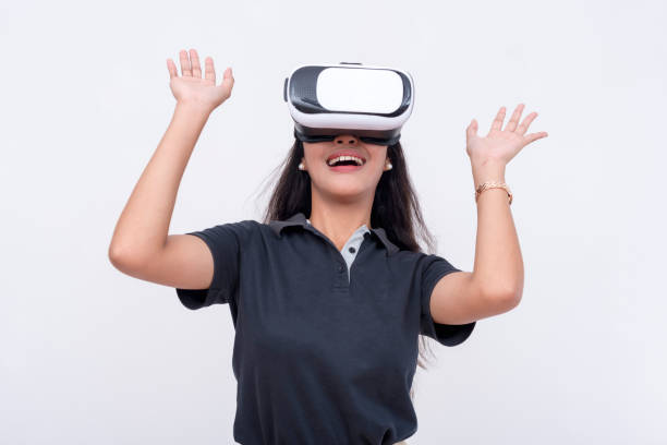 istock A young asian astonished and overwhelmed while exploring a VR environment via a virtual reality headset. Isolated on a white backdrop. 2158672646