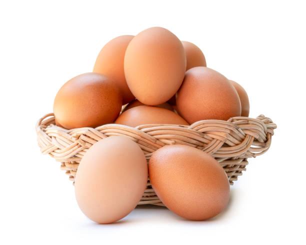 istock Front view of brown chicken eggs in stack in wicker basket isolated on white background with clipping path 2158676416