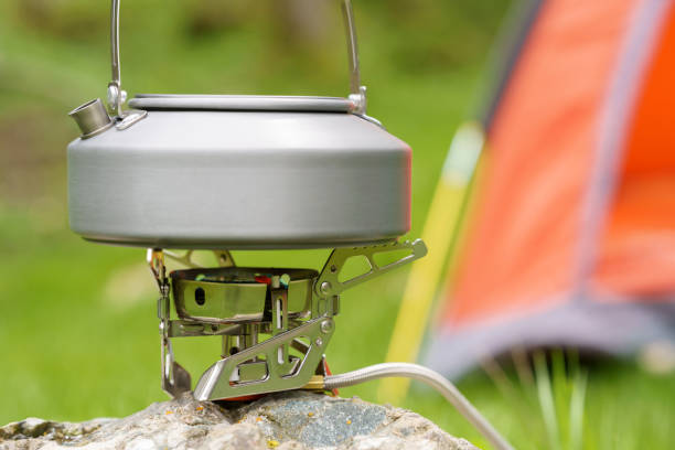 istock Boiling water with kettle at camping site, camping and adventure concept 2158678299