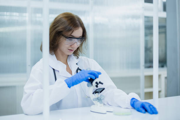 istock Science department students are working looking through microscope research in medical science. Analyze medical data advanced learning scientific chemistry biology. women scientist in laboratory. 2158679668