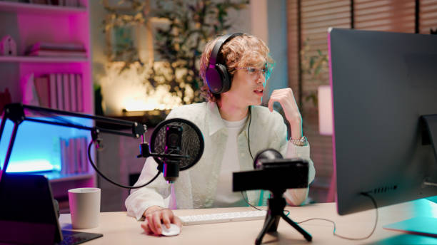 Young Asian man having conversation with her listener while holding a podcast session.