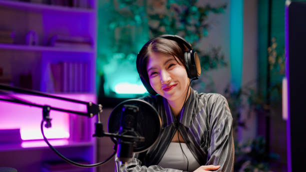 istock Young Asian woman sharing life experience with audience while holding a live podcast. 2158679735