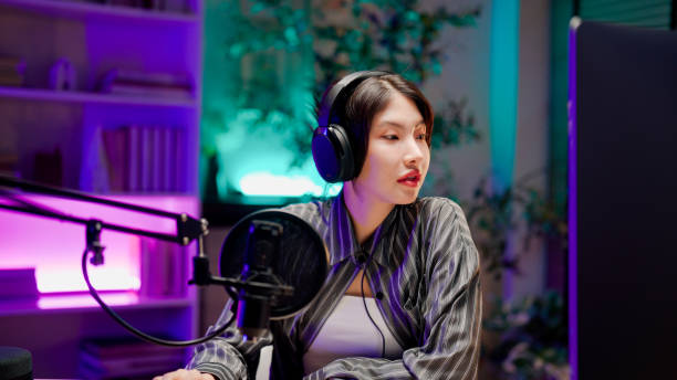 istock Young Asian woman sharing life experience with audience while holding a live podcast. 2158679736