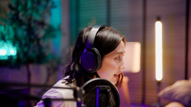 istock Young Asian woman opening visual aids while talking to audience during a podcast session. 2158679738