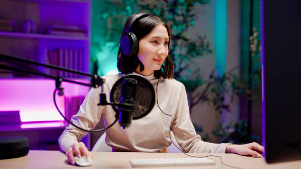 istock Young Asian woman opening visual aids while talking to audience during a podcast session. 2158679740
