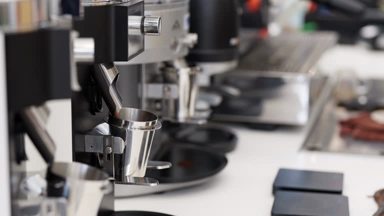 A barista skillfully grinds fresh coffee beans using a modern grinder in a vibrant coffee shop. Coffee preparation, highlighting the barista's expertise and the inviting atmosphere of the cafe. Hgh-quality, freshly ground coffee in creating