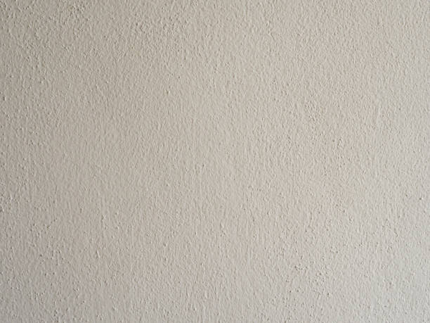 istock Close-up texture of a beige rough wall surface, perfect for backgrounds or design elements emphasizing raw materials and natural tones. 2158680069