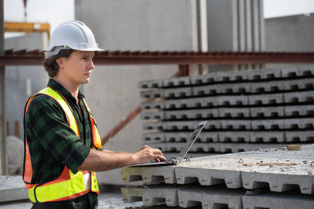 istock Portrait happy caucasian engineer man use notebook computer working at precast cement outdoor factory 2158681403
