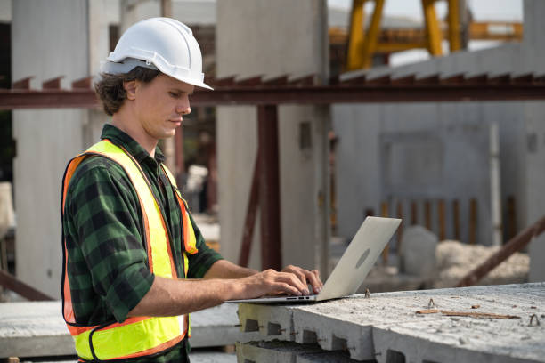 istock Portrait happy caucasian engineer man use notebook computer working at precast cement outdoor factory 2158681409