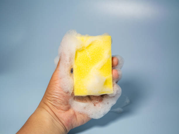 istock Hand holding foamy cleaning sponge 2158681958
