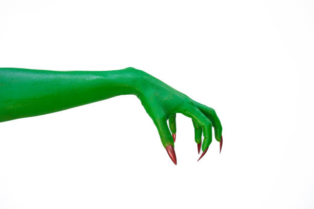 A green monster hand with long nails, isolated against a dark background, evokes horror and fear. Perfect for Halloween, this spooky image captures the essence of evil and the undead.