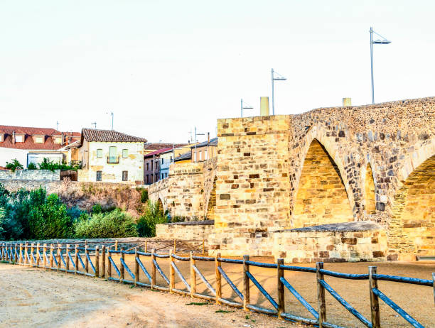 istock A bridge spans a river with a fence on the side 2158683343