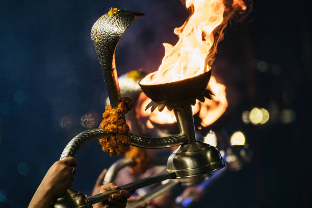 istock The visual depicts a person holding a torch with a snake coiled around them, Aarati ceremony on the Ganges in Varanasi, India 2158688210