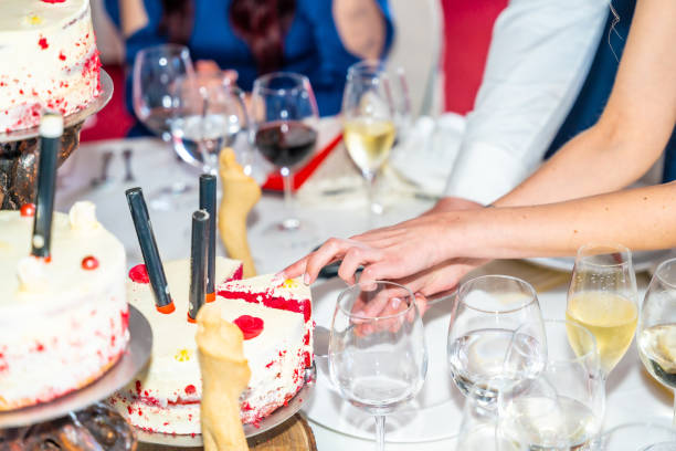 istock A couple is cutting a cake with candles on it 2158688560