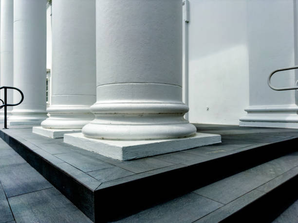 small sandstone staircase in front of columns on a facade
