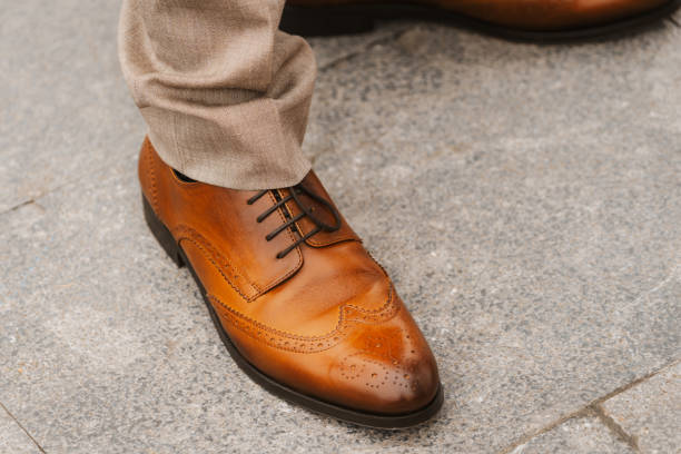 istock A man's brown shoe with a brown lace is shown on a gray stone floor 2158688829