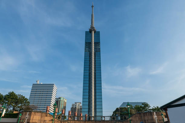 Fukuoka observation tower with city view from Momochi Seaside Park against blue sky, Kyushu, Japan. Famous travel destination to see aerial cityscape from tallest building.