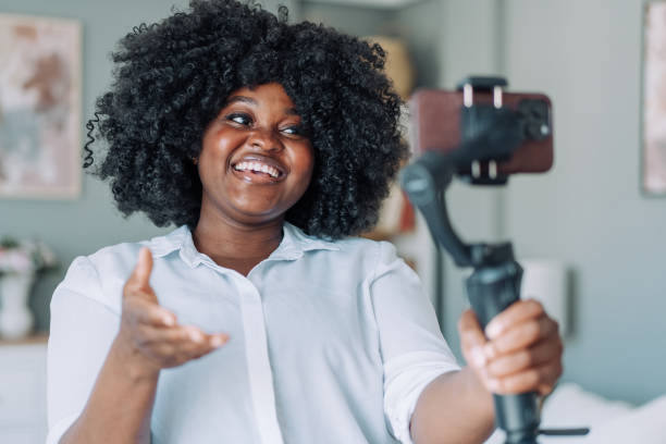 istock Young female content creator using smartphone to record vlog at home. 2158691807