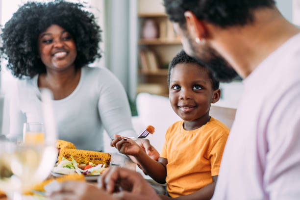 istock Young family enjoying lunch together. 2158691836
