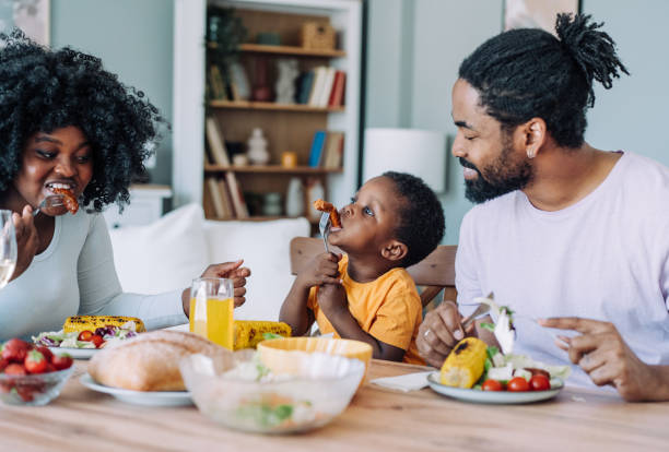 istock Young family enjoying lunch together. 2158691838