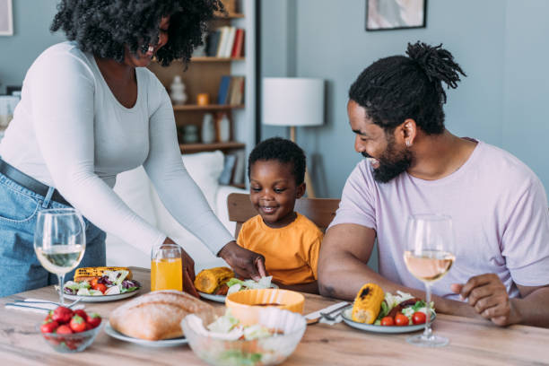 istock Young family enjoying lunch together. 2158691839