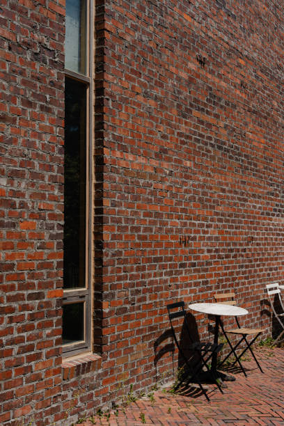 istock Brick Wall with Table and Chairs in Outdoor Setting 2158692451