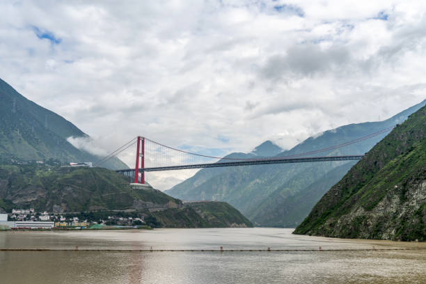 istock A bridge across the river built on the mountains on a cloudy day 2158696091